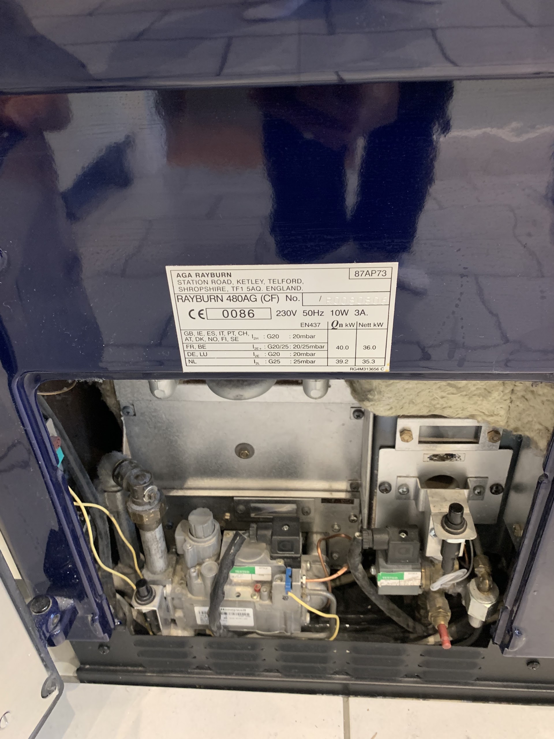 AGA cooker being serviced in a farmhouse kitchen
