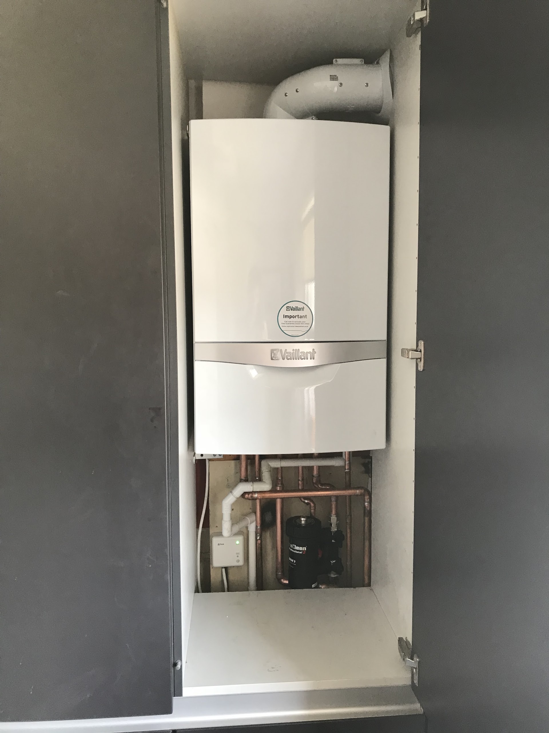 Vaillant combi boiler fitted in a kitchen cupboard, Essex